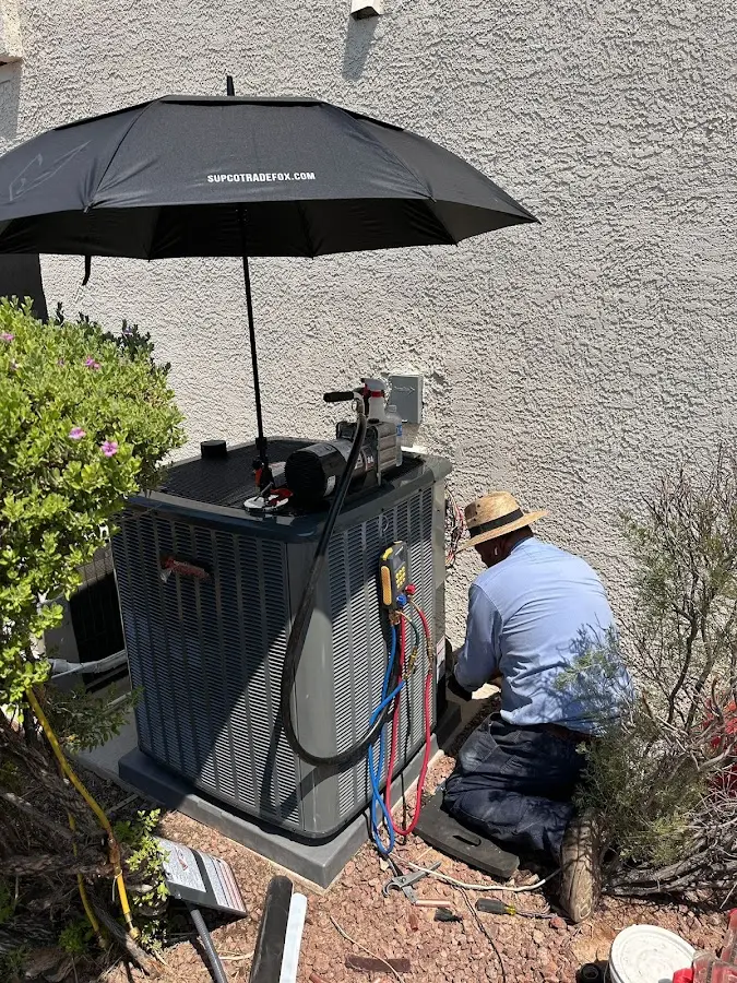 HVAC technician performing outdoor AC maintenance in Edna